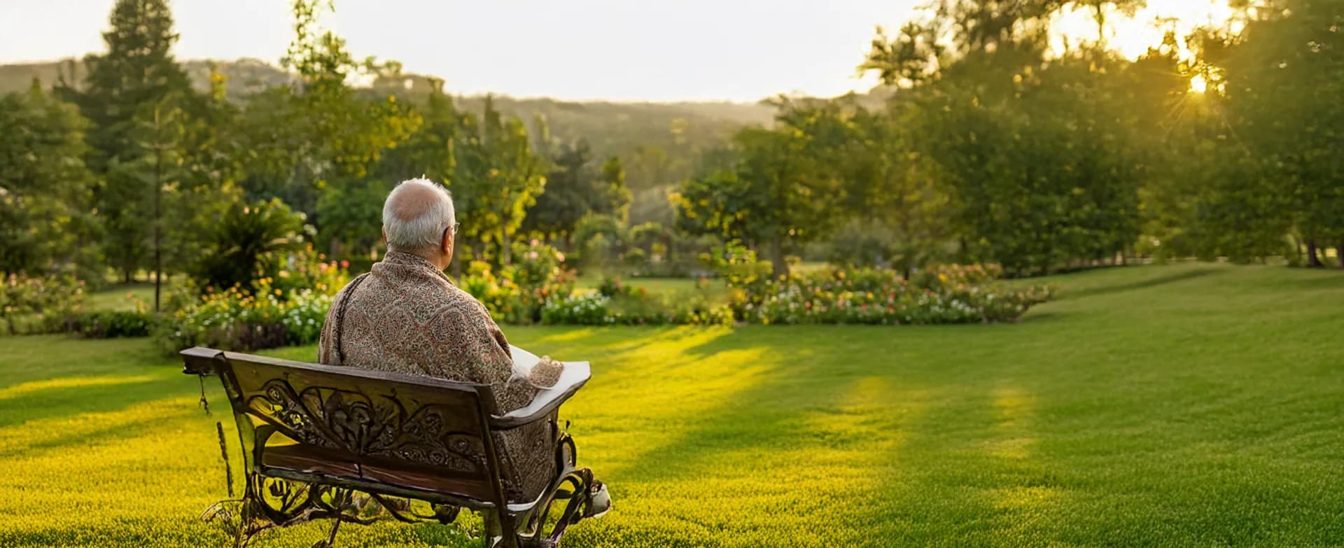 Zubair Kareem sitting on a garden bench, looking out over a sunlit lawn