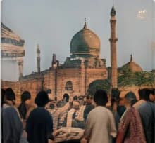 A crowd gathered in front of a domed mosque