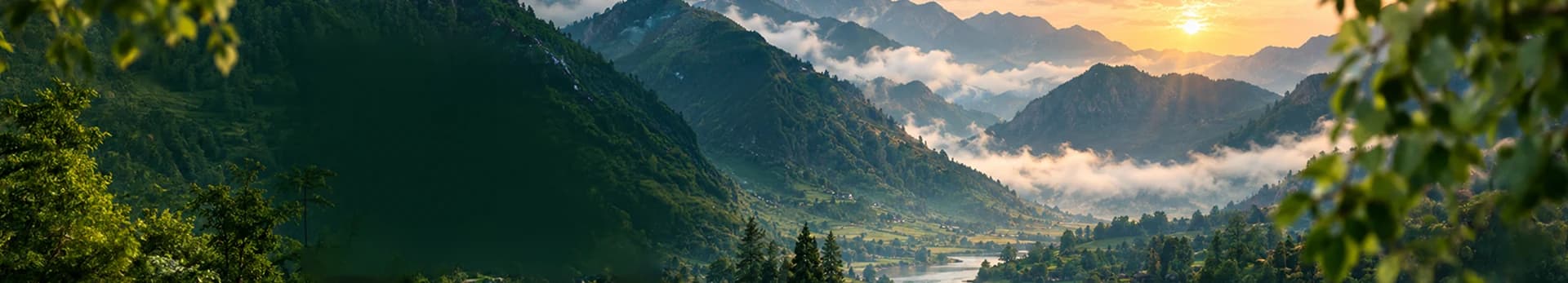 Sunrise over misty mountains and a green river valley